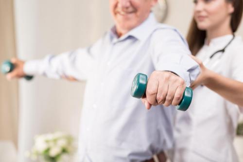 Retiree training with dumbbells